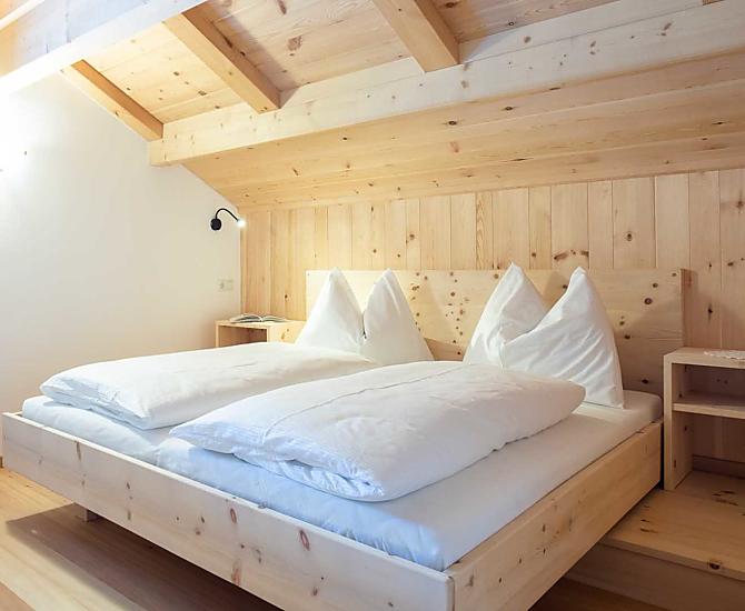 Doppelbett in Zirbenholz in der Empore.